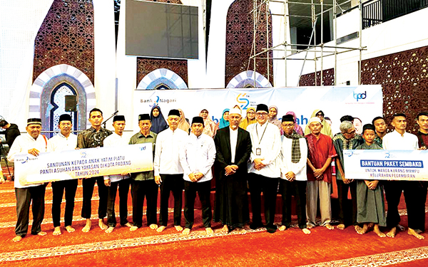 PENYERAHAN BANTUAN SOSIAL— Gubernur Sumbar Mahyeldi, Pjs Dirut Bank Nagari Gusti Candra, berfoto bersama stakeholder terkait serta warga dan panti asuhan penerima bantuan, Sabtu (2/3) usai kegiatan Subuh Mubarakoh di Masjid Raya Sumbar.