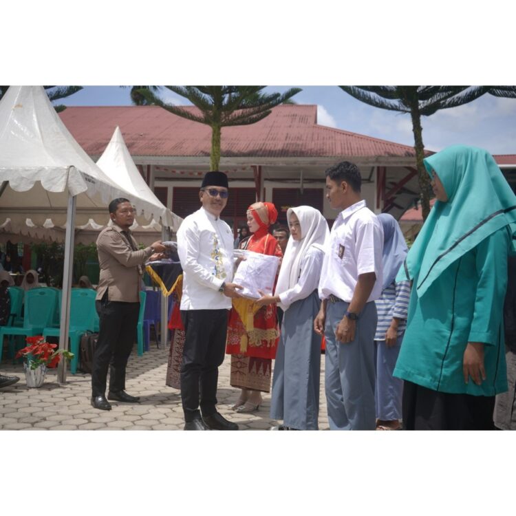 SERAGAM—Bupati Solok Selatan Khairunas, serahkan bantuan seragam gratis bagi peserta didik tahun ajaran 2024/2025 SMA dan SMK di Kecamatan Sangir, bertempat di SMA 3 N Solok Selatan, Jumat (20/9).