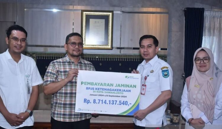 SIMBOLIS—Penyerahan simbolis jaminan BPJS Ketenagakerjaan di Sawahlunto sampai September 2024, diterima Pj Wali Kota Fauzan Hasan dari Kepala Cabang Solok Maulana Anshari Siregar