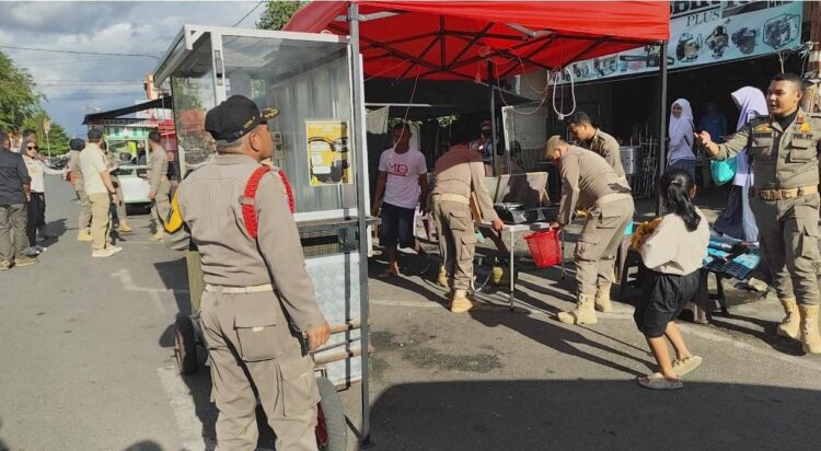 TERTIBKAN— Pol PP Kota Payakumbuh melakukan penertiban terhadap PKL di Jalan Sukarno-Hatta yang berjualan sebelum jam 4 sore.